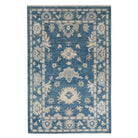 Traditional dark blue 3x5 Oushak area rug with soft ivory and beige geometric medallions and a distressed finish.