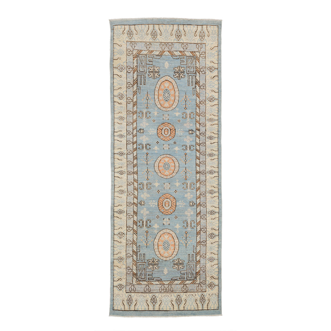 Light blue Oushak area rug runner with peach oval medallions and a wide ivory border with tree motifs.