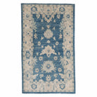 Traditional 3x5 accent area rug with a dark blue central floral design, ivory borders, and a distressed finish.