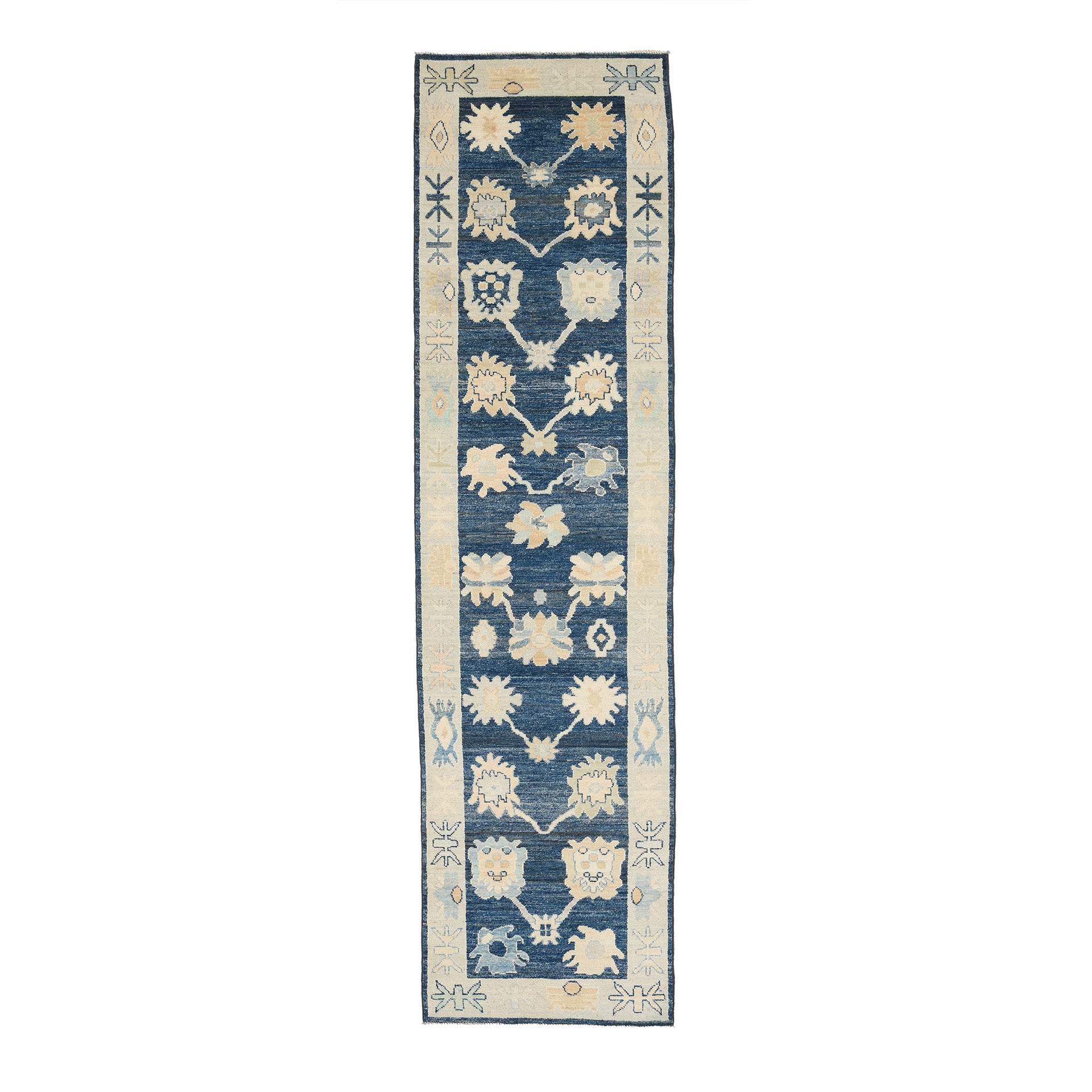 Traditional dark blue Oushak runner rug with a climbing floral motif, peach and beige accents, and a wide ivory border.