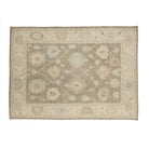 Taupe brown 10x14 Oushak area rug with light blue and ivory lattice floral medallions.