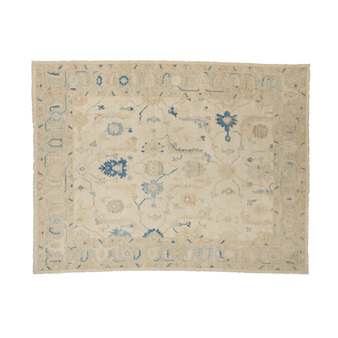 Warm vanilla 9x12 Oushak area rug with light blue floral motifs and dark blue geometric accents.