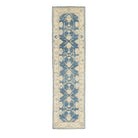 Traditional dark blue Oushak runner rug with soft peach and beige floral medallions, ivory borders, and a distressed finish.