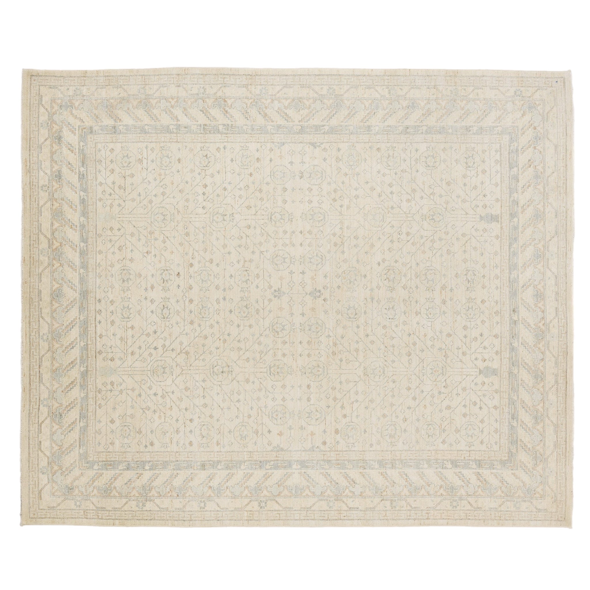 Ultra-faded cream 8x10 Khotan area rug with pale blue tree-of-life motifs and a geometric multi-tiered border.