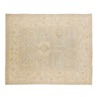 Soft light blue-grey 8x10 Oushak area rug with light cream floral motifs and a broad cream border.