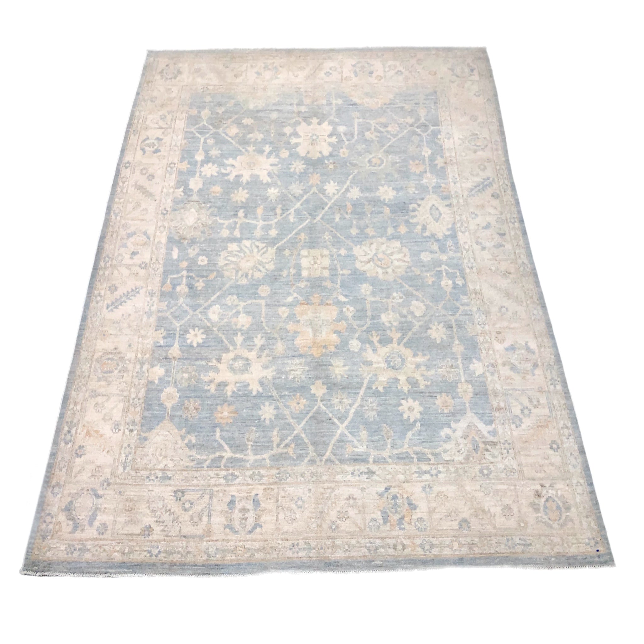 Soft light teal 8x10 Oushak area rug with cream floral palmettes and a broad cream border.