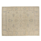 Sand beige 9x12 Oushak area rug with slate blue central floral lattice and matching border motifs.