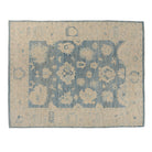 Rich dark blue 9x12 Oushak area rug with beige star cartouches and light blue floral accents.