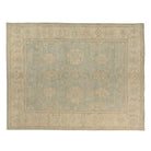 Soft light blue 9x12 Oushak area rug with warm beige floral palmettes and a wide beige border.