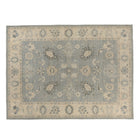 Slate blue 9x12 Oushak area rug with cream floral medallions and charcoal accents framing a cream border.