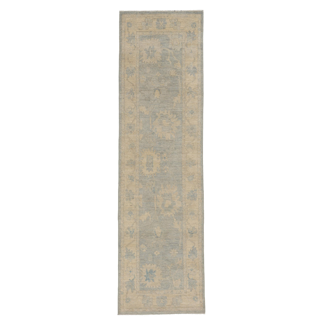 Ultra-faded light blue Oushak area rug runner with soft ivory floral motifs and a warm beige border.