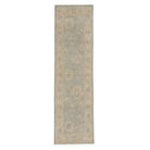 Ultra-faded light blue Oushak area rug runner with soft ivory floral motifs and a warm beige border.