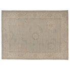 Hand-knotted 10x14 Oushak area rug with a faded light blue center field, ivory border, and soft sage green details.
