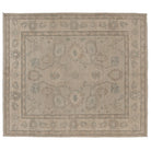 Hand-knotted 8x10 Oushak area rug with a warm khaki center field, soft ivory details, and light blue accents.