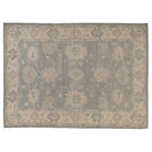 Hand-knotted 10x14 Oushak area rug with a muted slated aqua center field, ivory border, and soft taupe details.