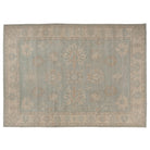 Hand-knotted 10x14 Oushak area rug with a muted aqua center field, warm camel details, and a soft ivory border.