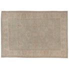 Hand-knotted 10x14 Oushak area rug with a muted greenish-aqua field, detailed taupe palmettes, and an ivory border.