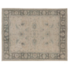 Hand-knotted 9x12 Oushak area rug with a light ivory center field, bold deep brown border, and soft blue accents.