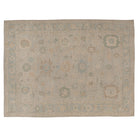 Hand-knotted 10x14 Oushak area rug with a camel and mocha field, geometric medallions, and an airy light blue border.