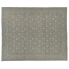Hand-knotted 8x10 Khotan area rug featuring a muted chambray blue field with an all-over ivory circular lattice design.