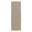 Soft light blue traditional Oushak runner rug with a muted beige floral border and distressed charcoal accents.