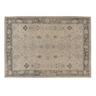 Cream 10x14 Oushak area rug with light blue floral medallions and a bold cocoa brown border.
