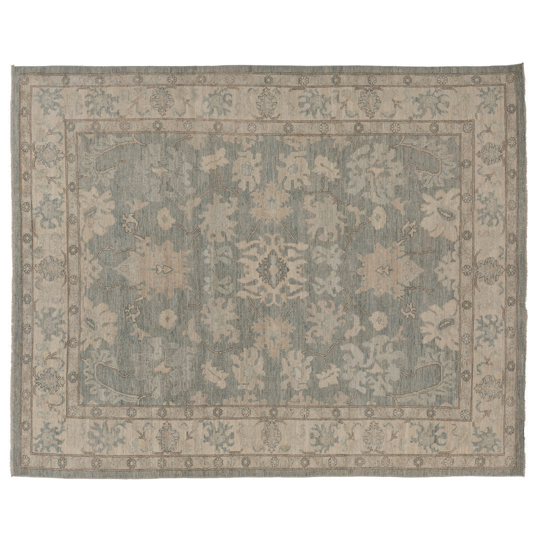 Hand-knotted 8x10 Oushak area rug with a muted slate blue field, soft ivory palmettes, and an ivory-beige border.