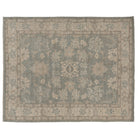 Hand-knotted 8x10 Oushak area rug with a muted slate blue field, soft ivory palmettes, and an ivory-beige border.