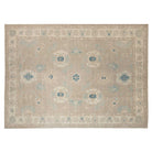 Warm camel 10x14 Oushak area rug with ivory cartouches and medium blue geometric accents.