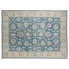 Deep blue 10x14 Oushak area rug with ivory floral palmettes and a wide cream border.
