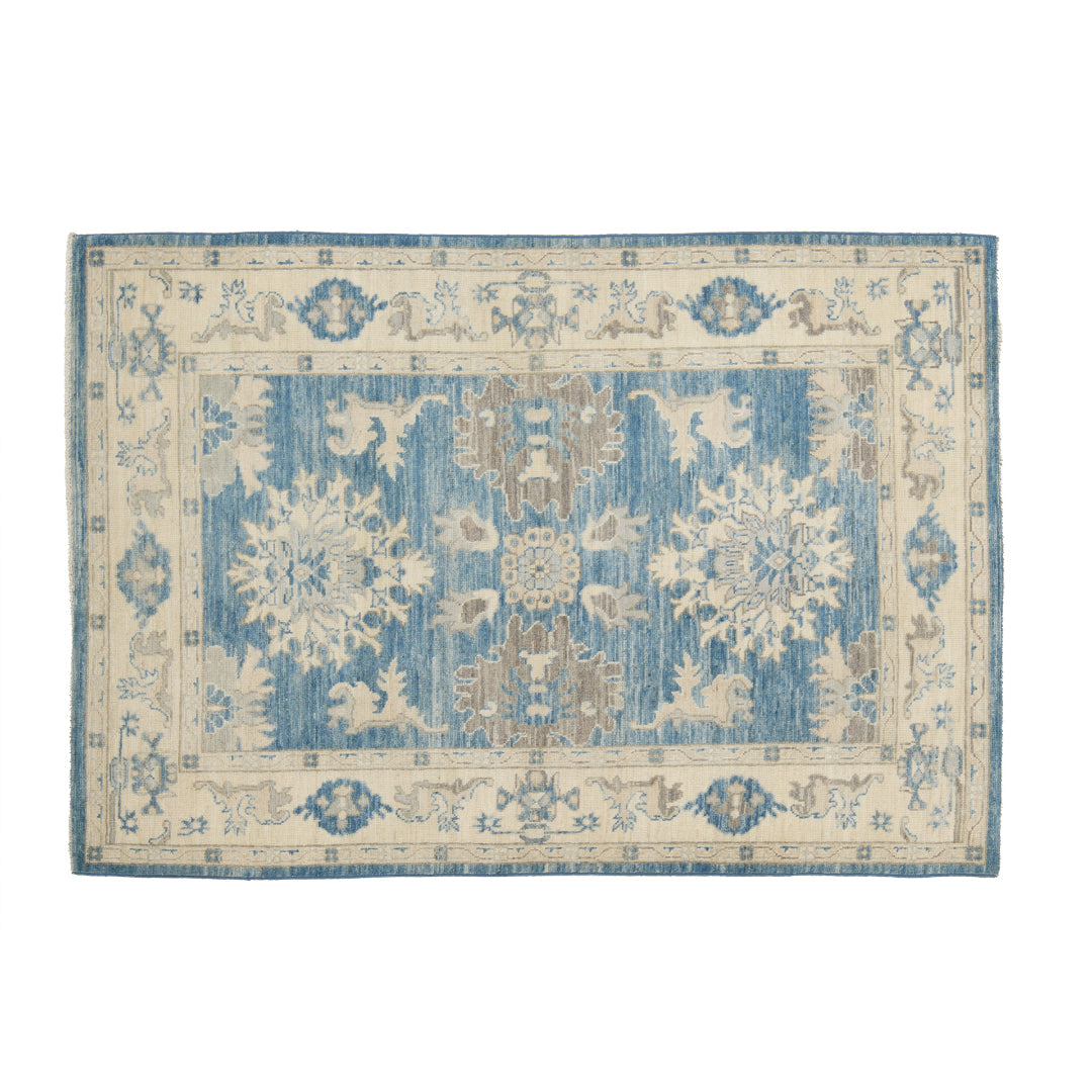 Dark blue 4x6 Oushak area rug with beige floral star medallions and a brown central accent framed by an ivory border.