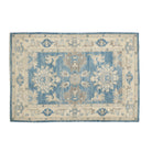 Dark blue 4x6 Oushak area rug with beige floral star medallions and a brown central accent framed by an ivory border.