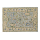 Traditional light blue 4x6 Oushak area rug with sage green and beige botanical motifs, diamond guards, and a distressed beige-cream border.