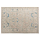 Ultra-faded cream 4x6 Oushak area rug with taupe floral motifs and deep blue accents.