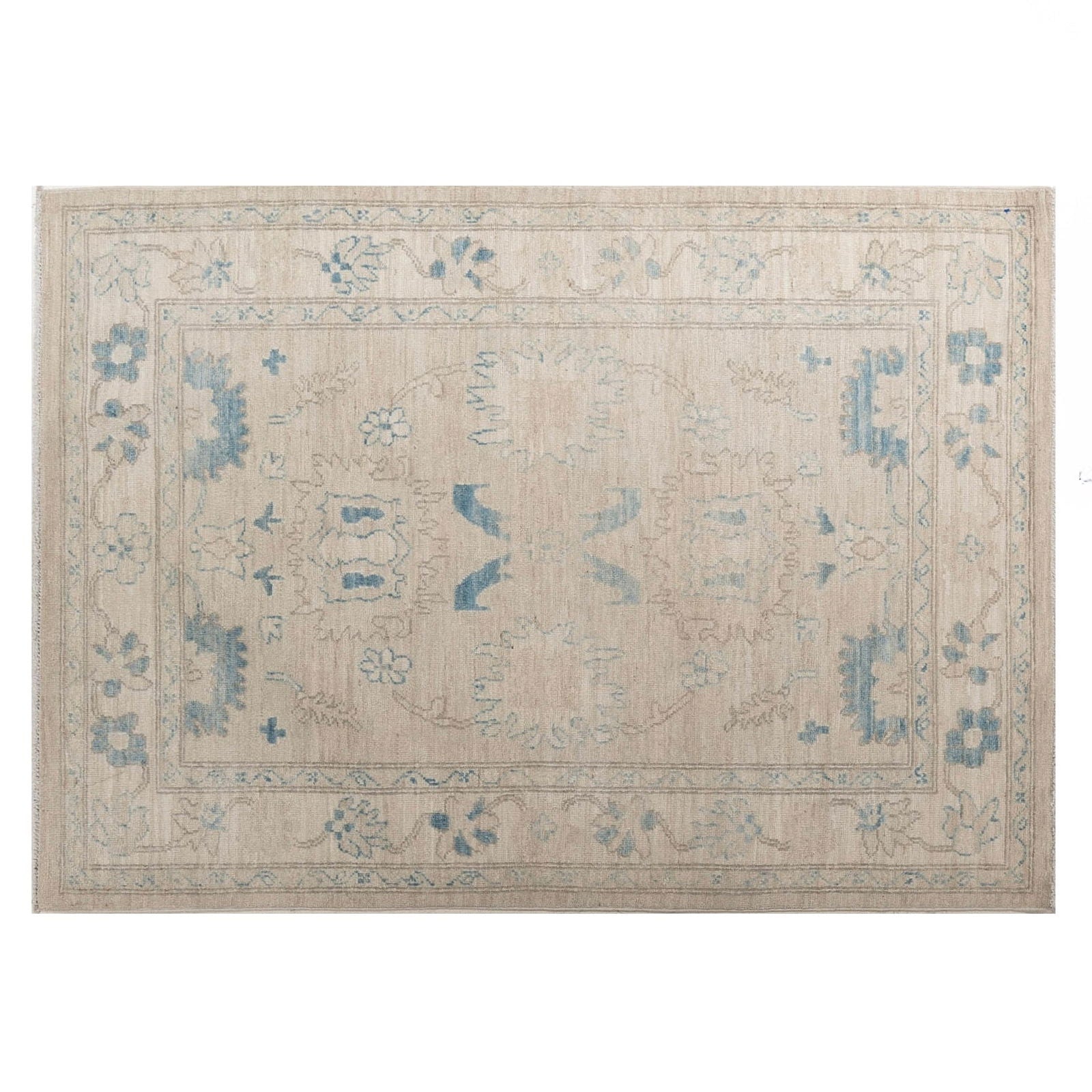 Ultra-faded cream 4x6 Oushak area rug with taupe floral motifs and deep blue accents.
