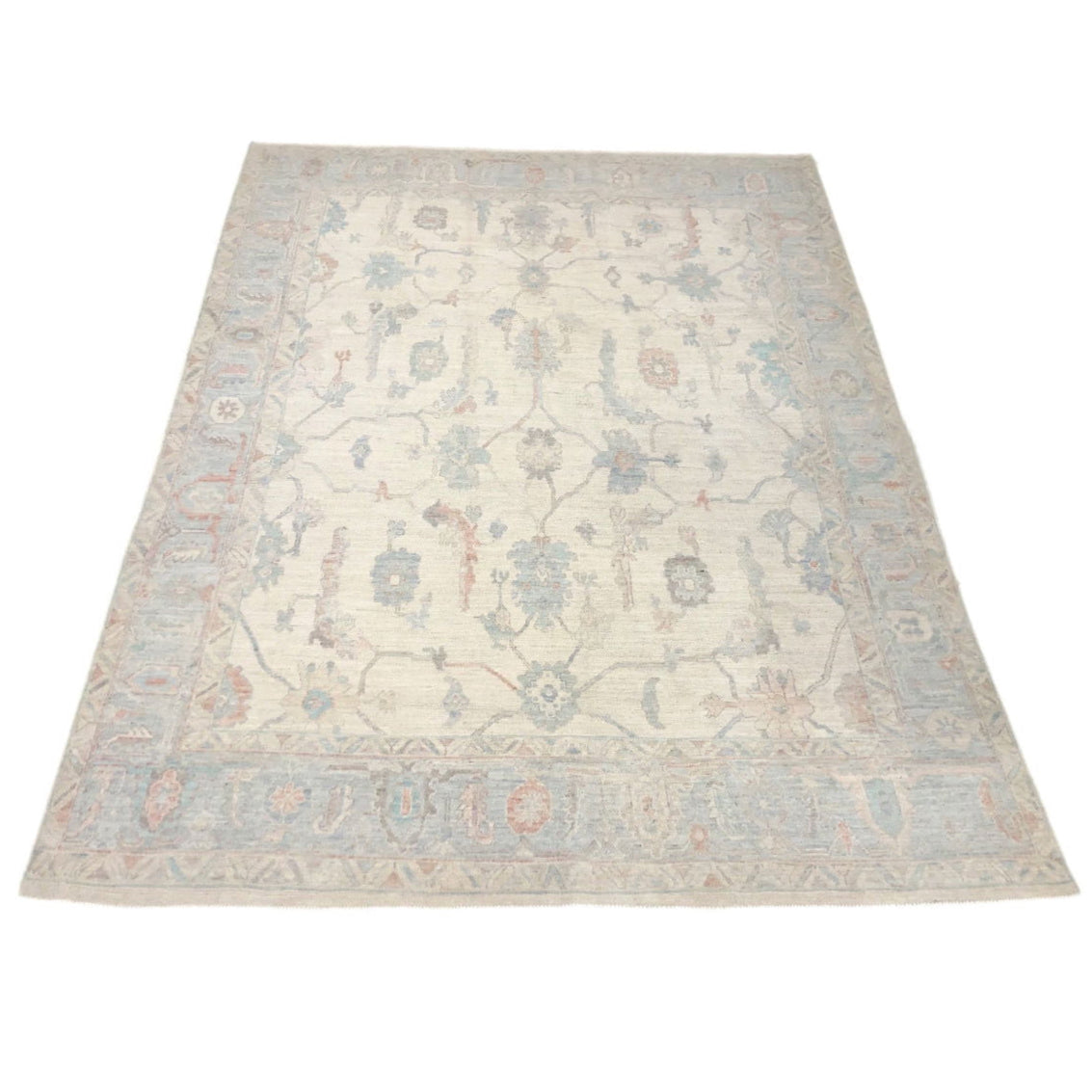 Luminous cream 8x10 Oushak area rug with light blue floral medallions and light coral accents.