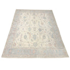 Luminous cream 8x10 Oushak area rug with light blue floral medallions and light coral accents.