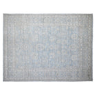 Soft aqua blue 9x12 Oushak area rug with seamist green floral motifs and a wide cream border.