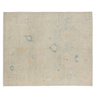 Ultra-faded light blue 8x10 Oushak area rug with cream floral motifs and deep blue accents.